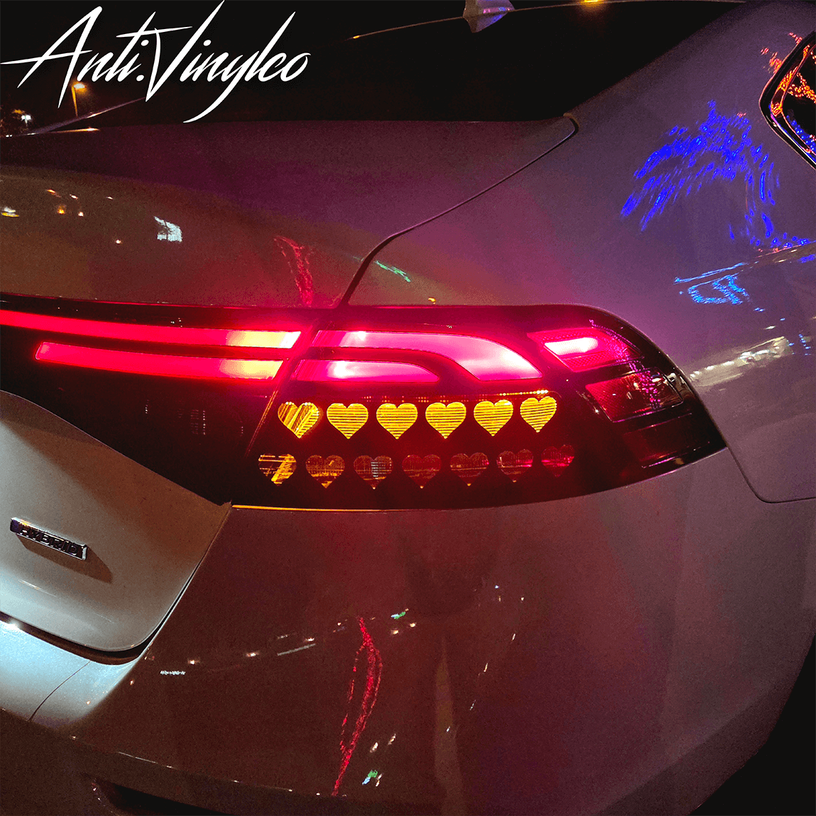 Custom turn signal overlays on a Honda Accord, featuring stylish heart designs in vibrant red and yellow lights.