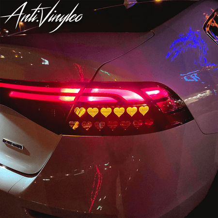 Custom turn signal overlays on a Honda Accord, featuring stylish heart designs in vibrant red and yellow lights.