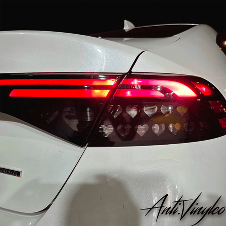 Turn signal overlays on a white Honda Accord, showcasing heart-shaped cutouts for a stylish touch.