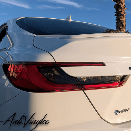 Close-up of a white 2025+ Toyota Camry featuring reverse and turn signal tint set.