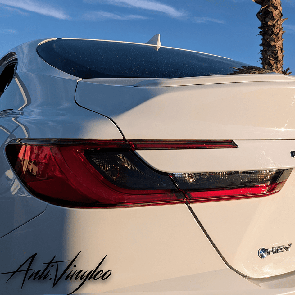 Close-up of a white 2025+ Toyota Camry featuring reverse and turn signal tint set.